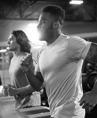 gym members running on treadmills