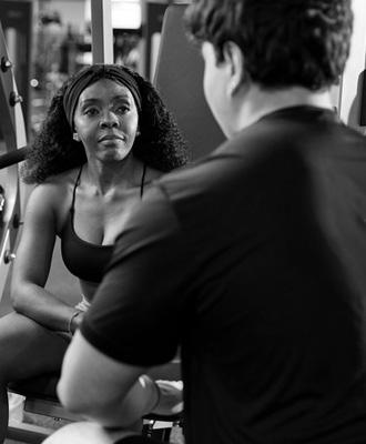 gym trainer talking to a gym member